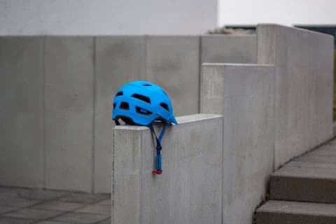 wearing a hat under a bike helmet