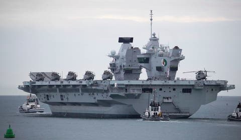 In this file photo, the British Royal Navy aircraft carrier HMS Queen Elizabeth leaves Portsmouth Naval Base as it sets sail for flight trials, Wednesday Sept. 9, 2020. The departure comes following two days of delays caused by a small number of crew members testing positive for the coronavirus. (Andrew Matthews/PA via AP) **FILE**